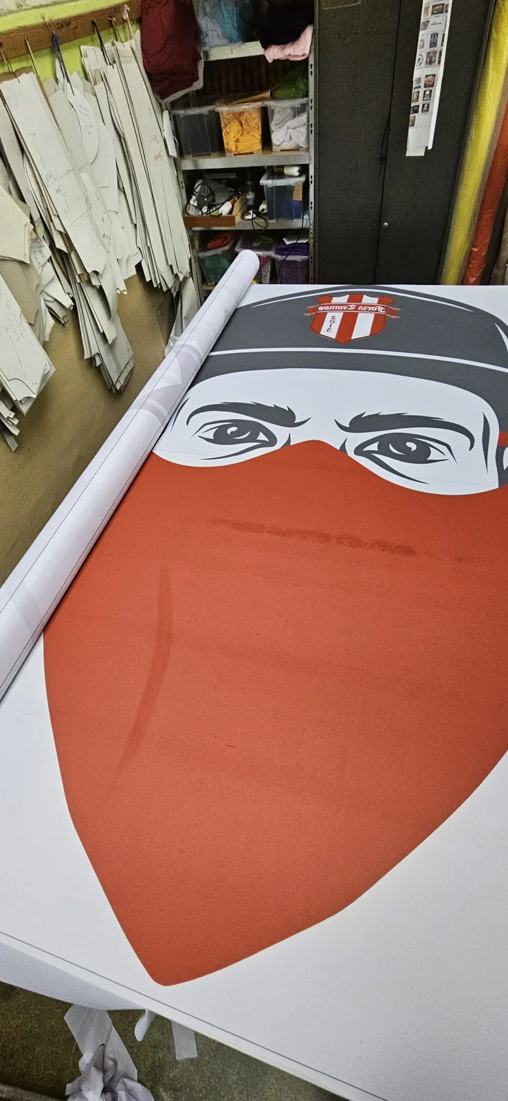 Flag with a masked-face graphic rolled on the pole sleeve side