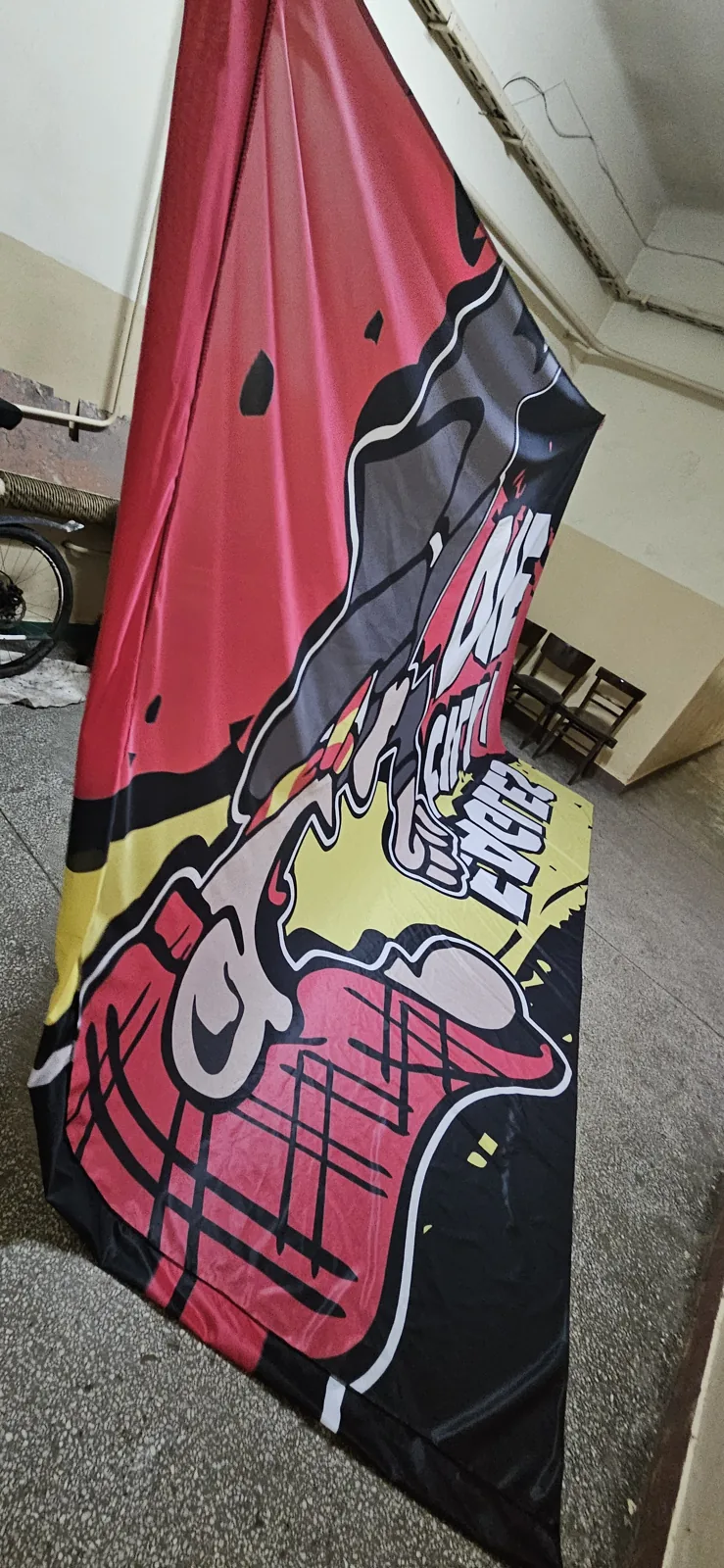 Red and yellow cartoon flag hanging in the production hall