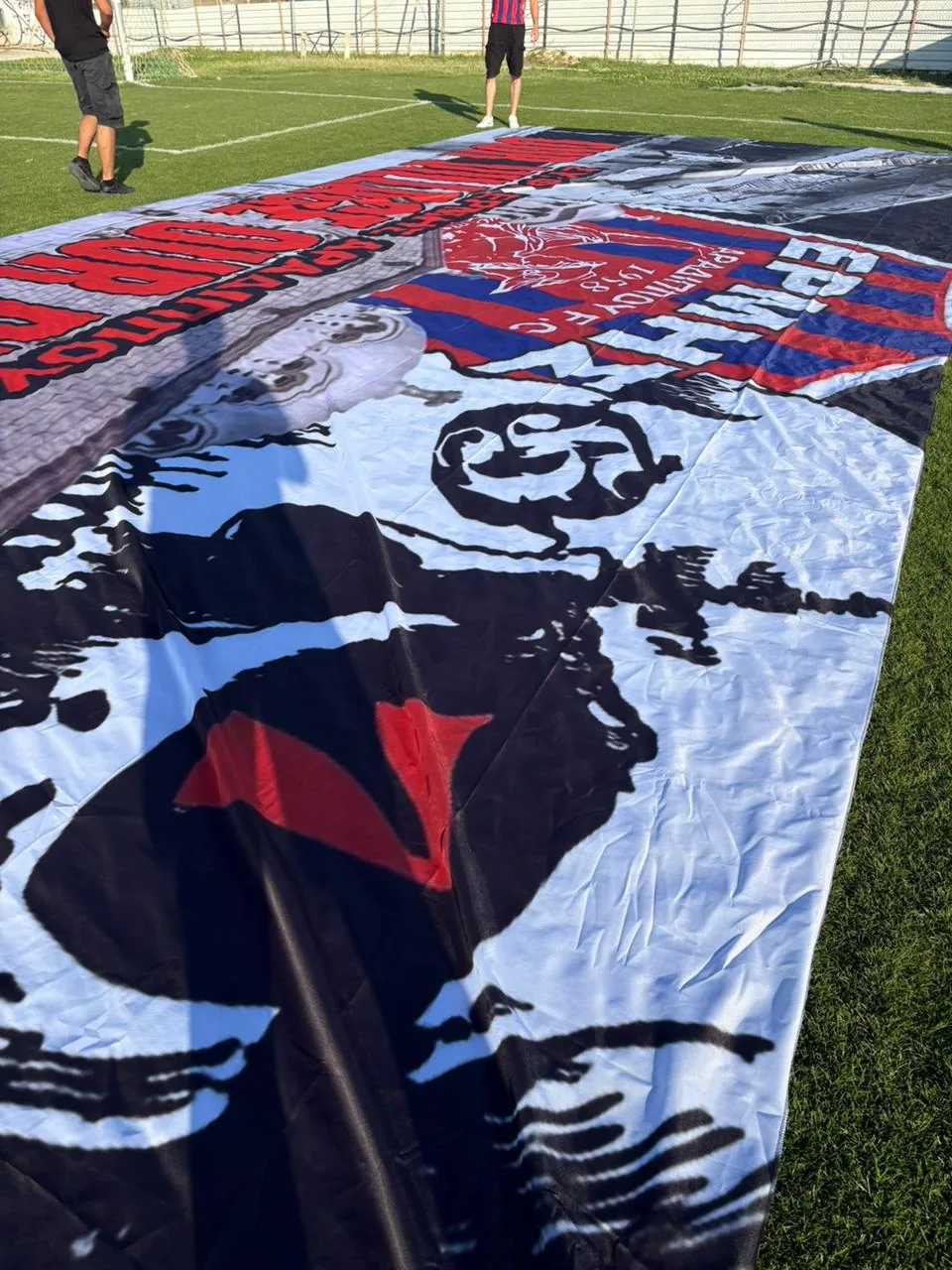 Red, black and white sector flag with a portrait graphic